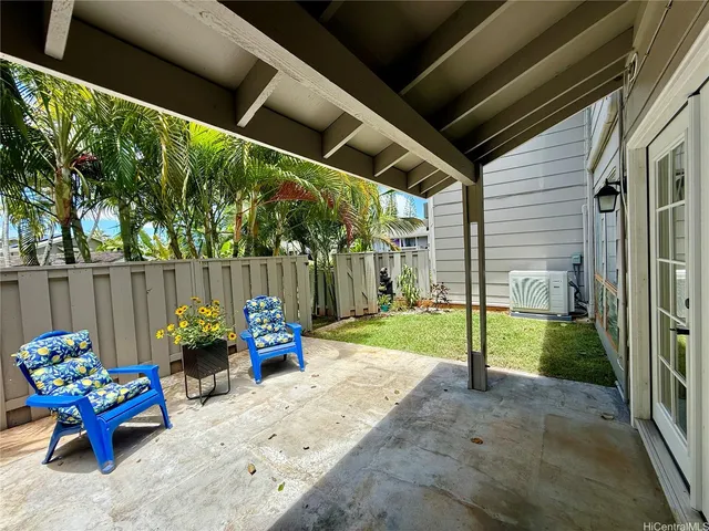 a backyard of a house with table and chairs