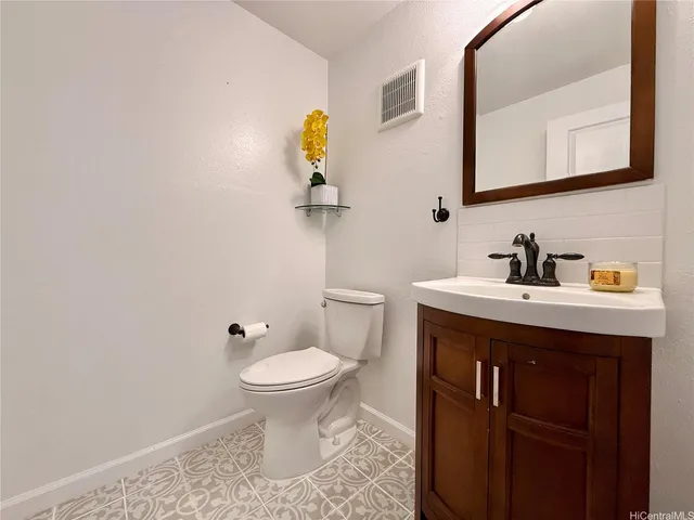 a bathroom with a sink a toilet and mirror