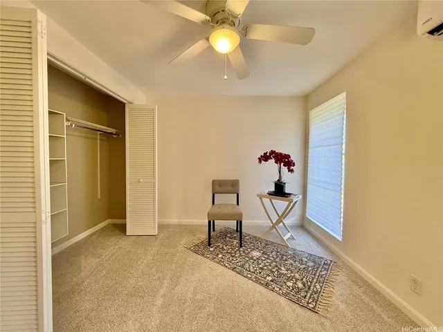 a view of a livingroom with furniture and a ceiling fan