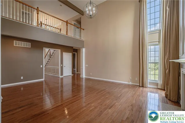 a kitchen with kitchen island wooden floors and stainless steel appliances