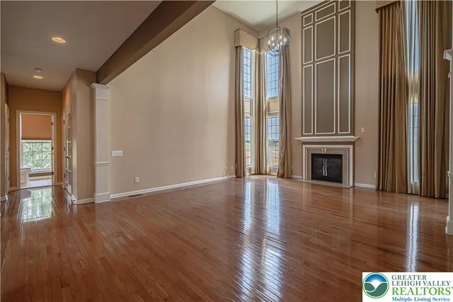 a kitchen with a stove sink cabinets and wooden floor