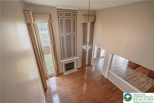 a kitchen with stainless steel appliances granite countertop a stove a sink dishwasher and a refrigerator with wooden cabinets