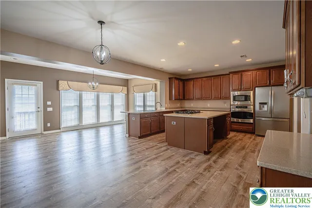 a kitchen with granite countertop a sink and cabinets