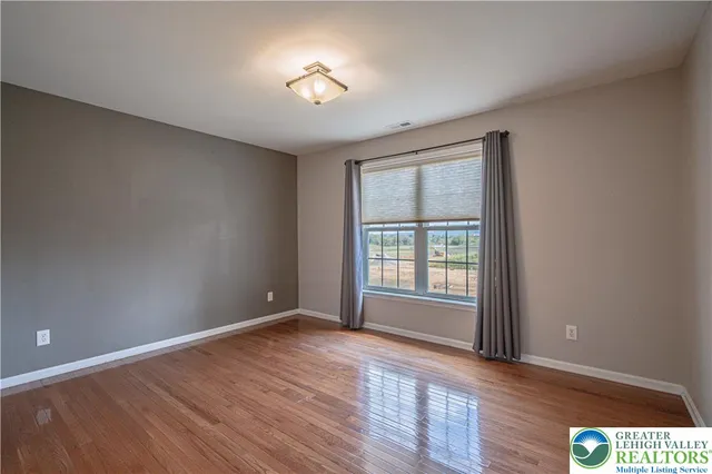 a view of empty room with wooden ceiling