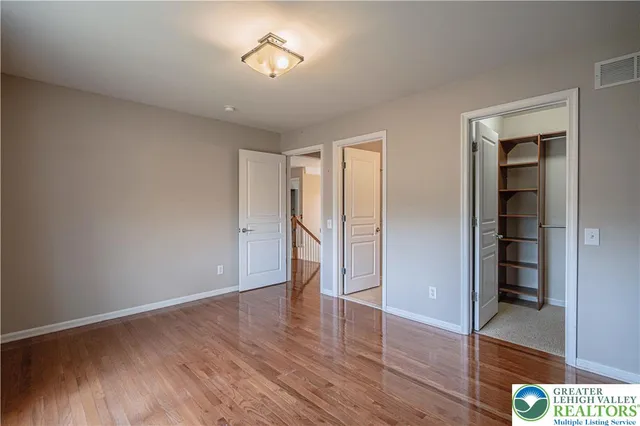 a storage room with wooden floor and furniture