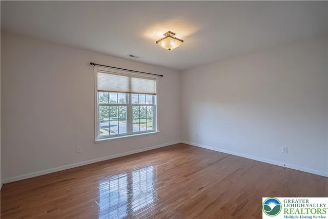 a large house with a big yard and large trees