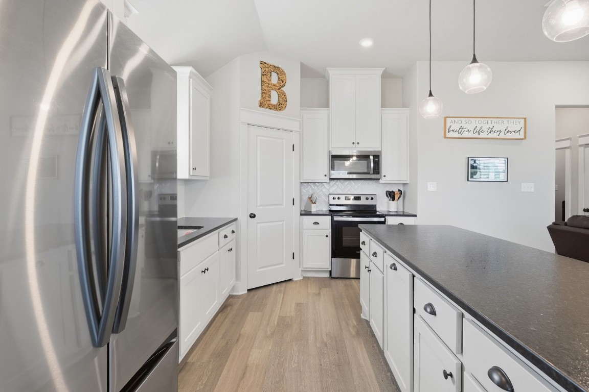 173 Brazos Bend Snook, TX 77879 - Photo 17 of 41 a kitchen with stainless steel appliances granite countertop a refrigerator a stove and a sink