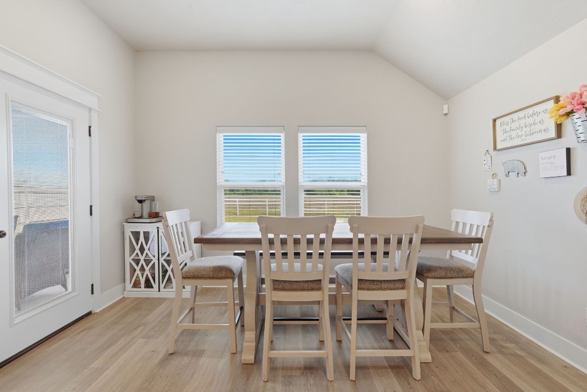 173 Brazos Bend Snook, TX 77879 - Photo 20 of 41 a dining room with furniture a chandelier and wooden floor