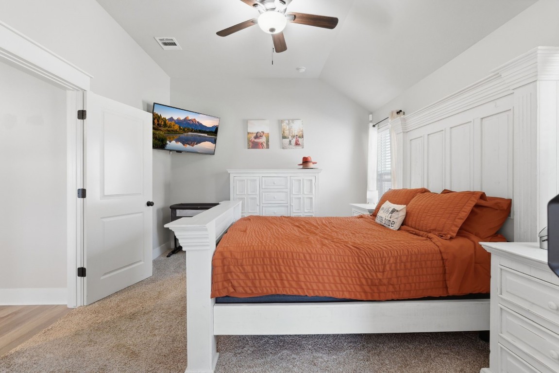 173 Brazos Bend Snook, TX 77879 - Photo 21 of 41 a bedroom with a bed and a chandelier
