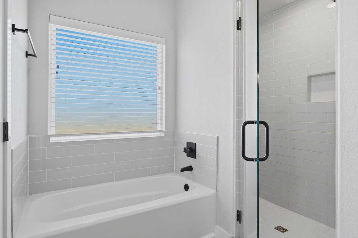 173 Brazos Bend Snook, TX 77879 - Photo 26 of 41 a bathroom with a bathtub and a shower