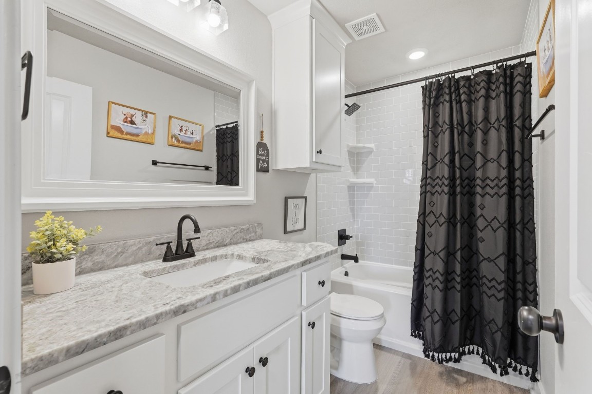 173 Brazos Bend Snook, TX 77879 - Photo 30 of 41 a bathroom with a granite countertop sink toilet and shower