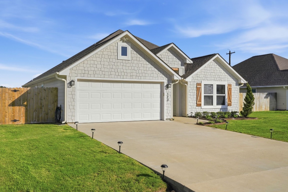 173 Brazos Bend Snook, TX 77879 - Photo 4 of 41 a front view of a house with a garden and yard