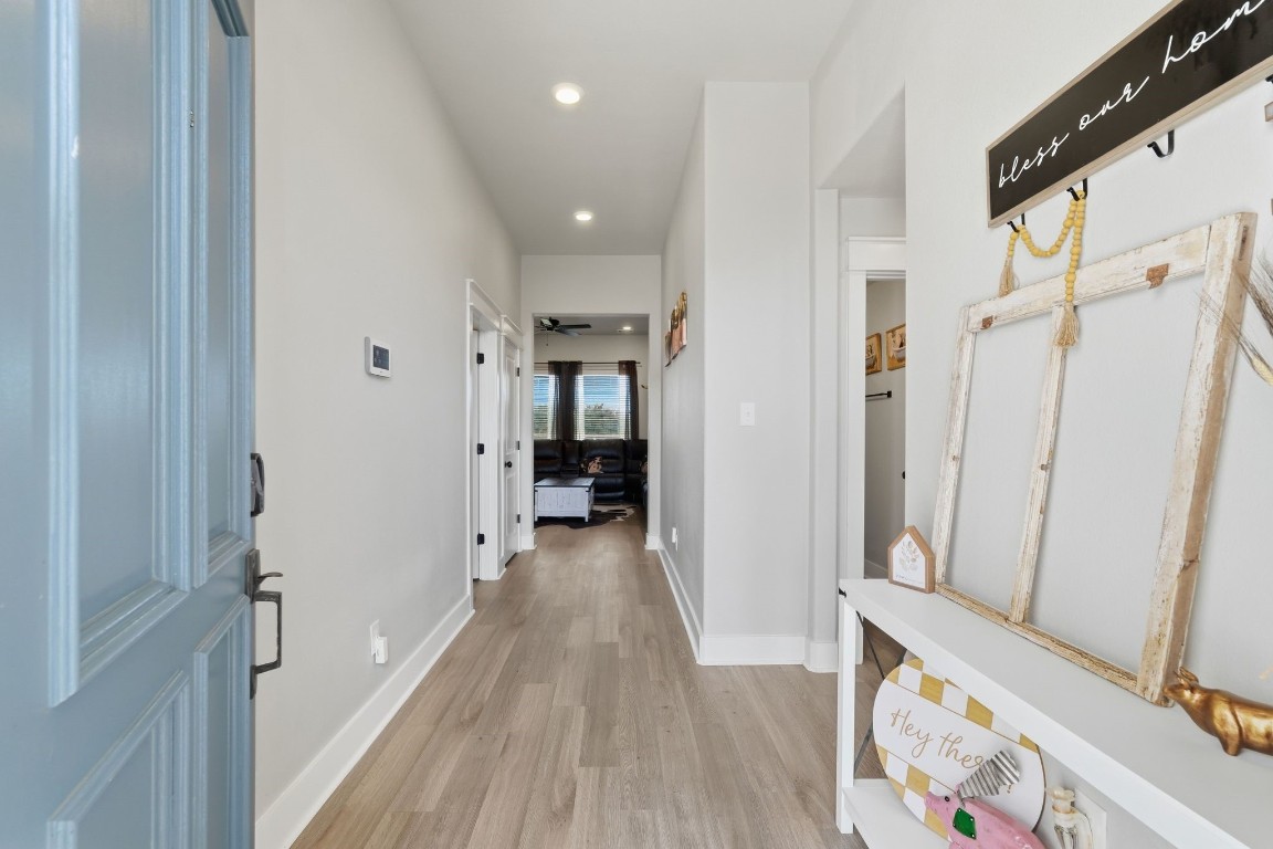 173 Brazos Bend Snook, TX 77879 - Photo 7 of 41 a view of a hallway with wooden floor and staircase