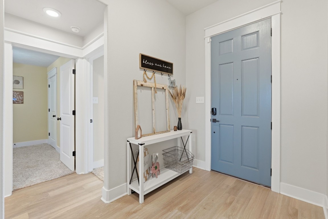 173 Brazos Bend Snook, TX 77879 - Photo 8 of 41 a view of a hallway with entryway wooden floor and cabinet