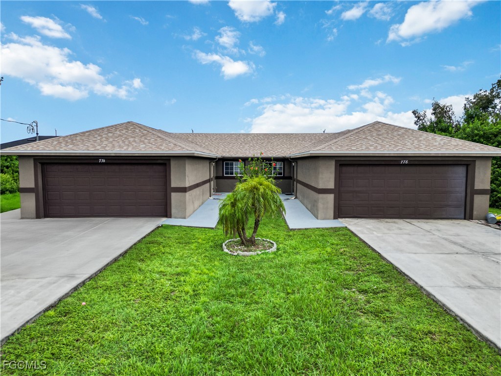 776-778 Alabama Road South Lehigh Acres, FL 33974 - Photo 1 of 50 a front view of a house with a garden