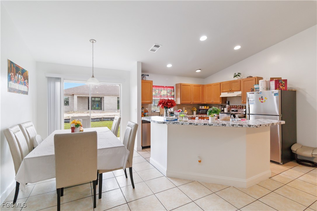 776-778 Alabama Road South Lehigh Acres, FL 33974 - Photo 13 of 50 a dining room filled kitchen with a table and chairs