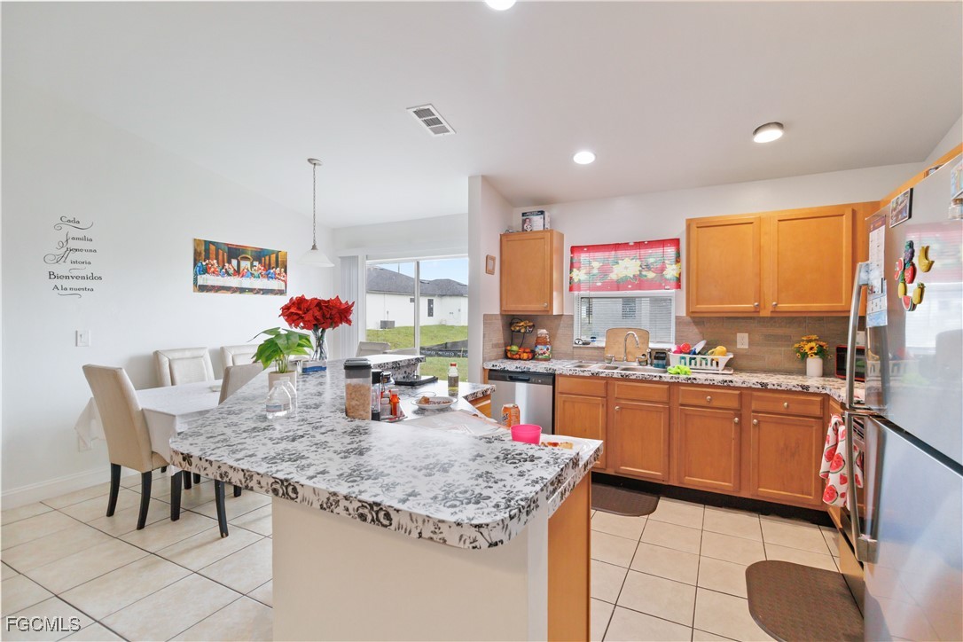 776-778 Alabama Road South Lehigh Acres, FL 33974 - Photo 14 of 50 a kitchen with stainless steel appliances granite countertop sink stove and cabinets
