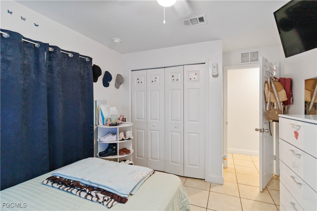776-778 Alabama Road South Lehigh Acres, FL 33974 - Photo 20 of 50 a bedroom with a bed and a refrigerator