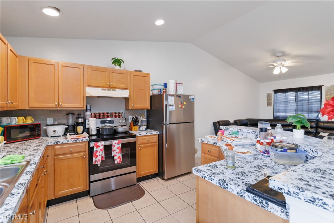 776-778 Alabama Road South Lehigh Acres, FL 33974 - Photo 2 of 50 a kitchen with stainless steel appliances granite countertop a sink dishwasher stove top oven and cabinets