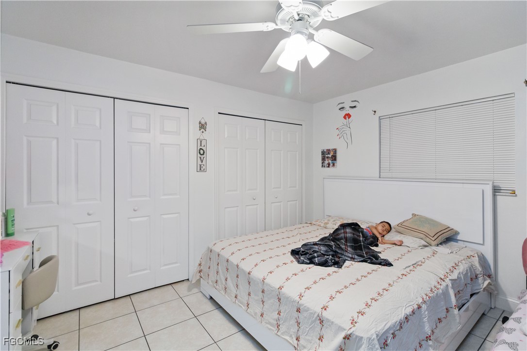 776-778 Alabama Road South Lehigh Acres, FL 33974 - Photo 22 of 50 a bedroom with a bed and a chandelier