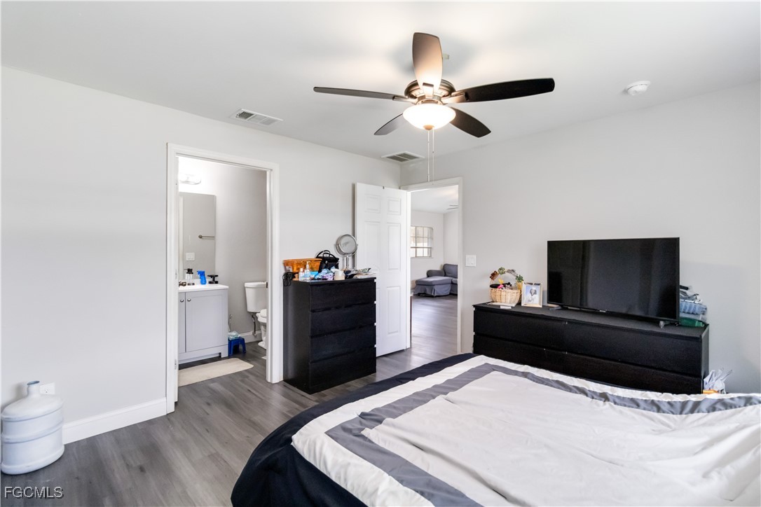 776-778 Alabama Road South Lehigh Acres, FL 33974 - Photo 25 of 50 a bedroom with a bed and a flat screen tv