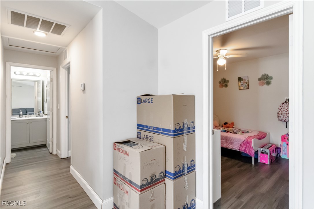 776-778 Alabama Road South Lehigh Acres, FL 33974 - Photo 30 of 50 a view of a bedroom with a bed and wooden floor