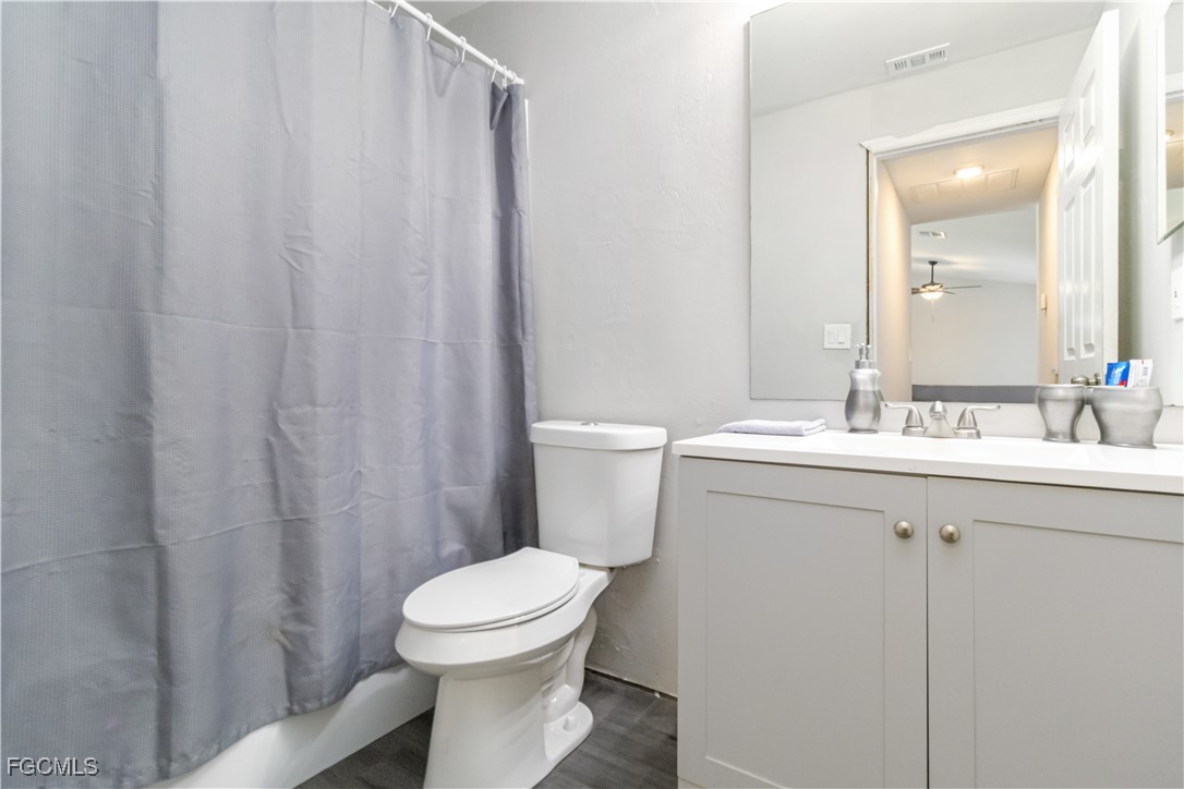 776-778 Alabama Road South Lehigh Acres, FL 33974 - Photo 33 of 50 a bathroom with a sink a toilet and shower curtain