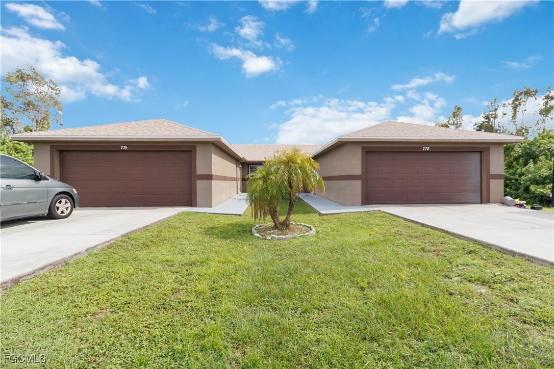 776-778 Alabama Road South Lehigh Acres, FL 33974 - Photo 38 of 50 a front view of a house with garden