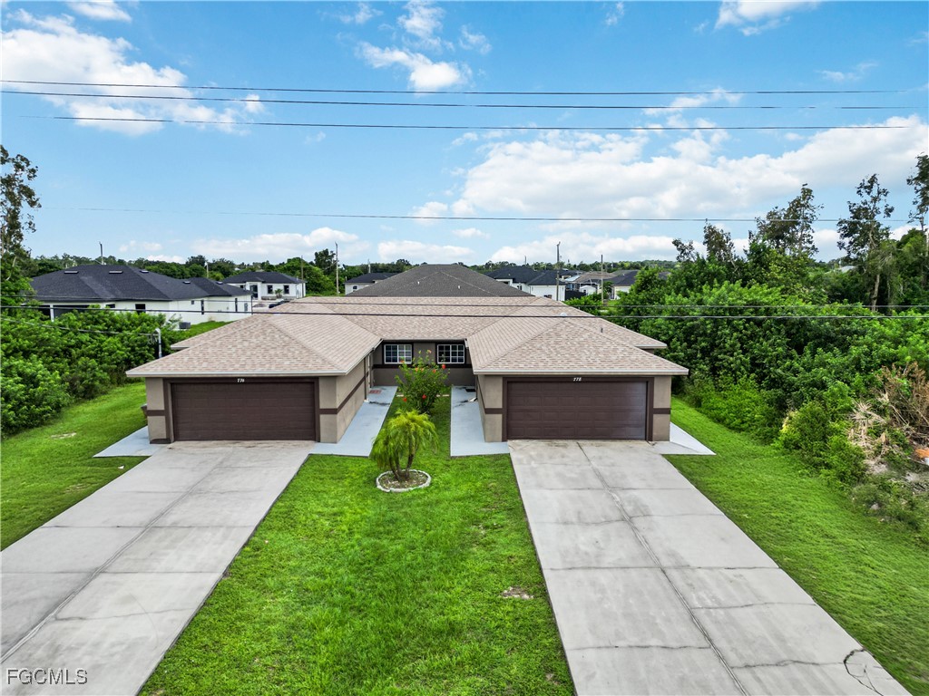 776-778 Alabama Road South Lehigh Acres, FL 33974 - Photo 39 of 50 a aerial view of a house with a yard