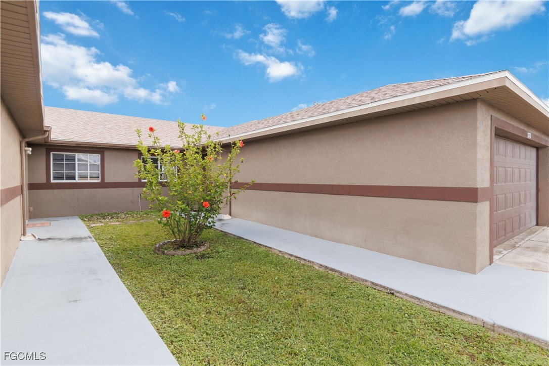 776-778 Alabama Road South Lehigh Acres, FL 33974 - Photo 43 of 50 a view of yellow house with a yard