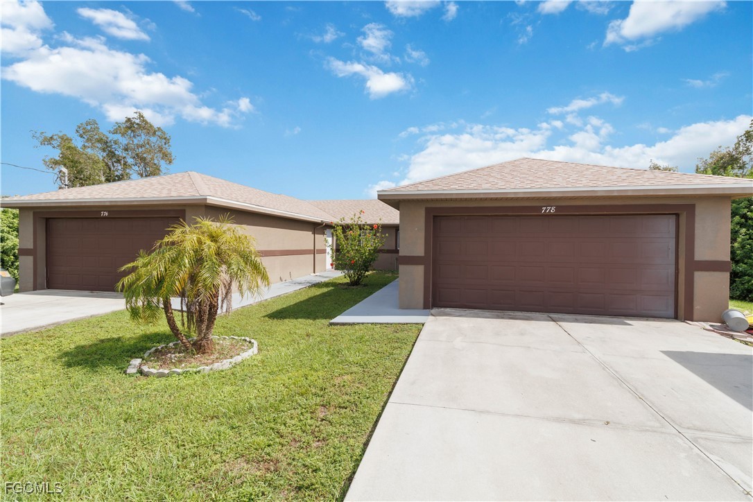 776-778 Alabama Road South Lehigh Acres, FL 33974 - Photo 45 of 50 a front view of a house with garden