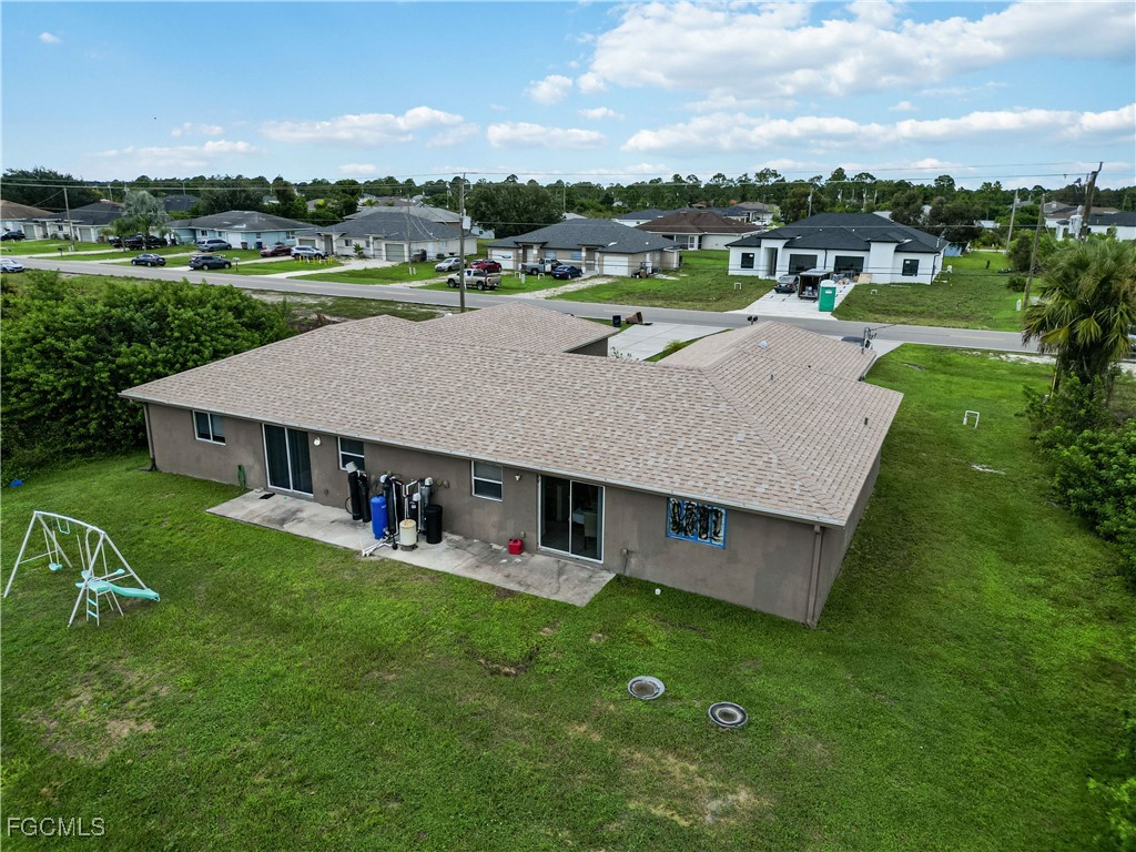 776-778 Alabama Road South Lehigh Acres, FL 33974 - Photo 46 of 50 an aerial view of a house with swimming pool garden and trees