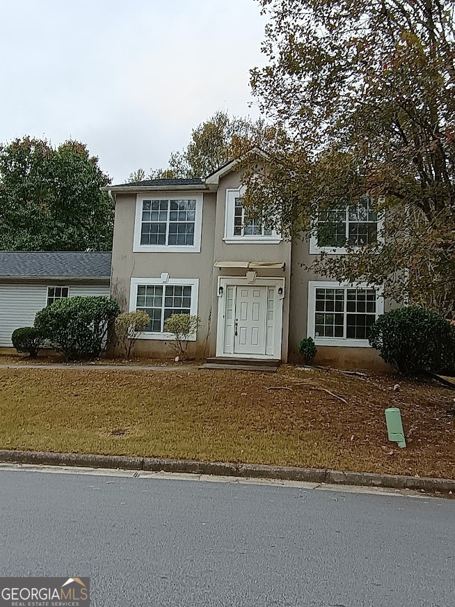 7355 Drake Avenue Lithonia, GA 30058 - Photo 1 of 20 a front view of a house with a garden