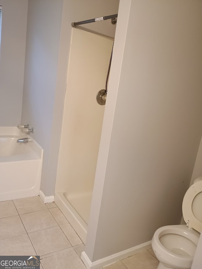 7355 Drake Avenue Lithonia, GA 30058 - Photo 15 of 20 a white toilet sitting next to a bath tub