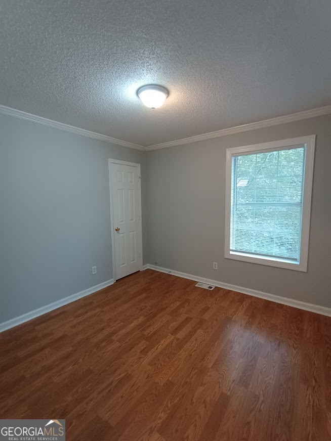 7355 Drake Avenue Lithonia, GA 30058 - Photo 16 of 20 an empty room with wooden floor and windows