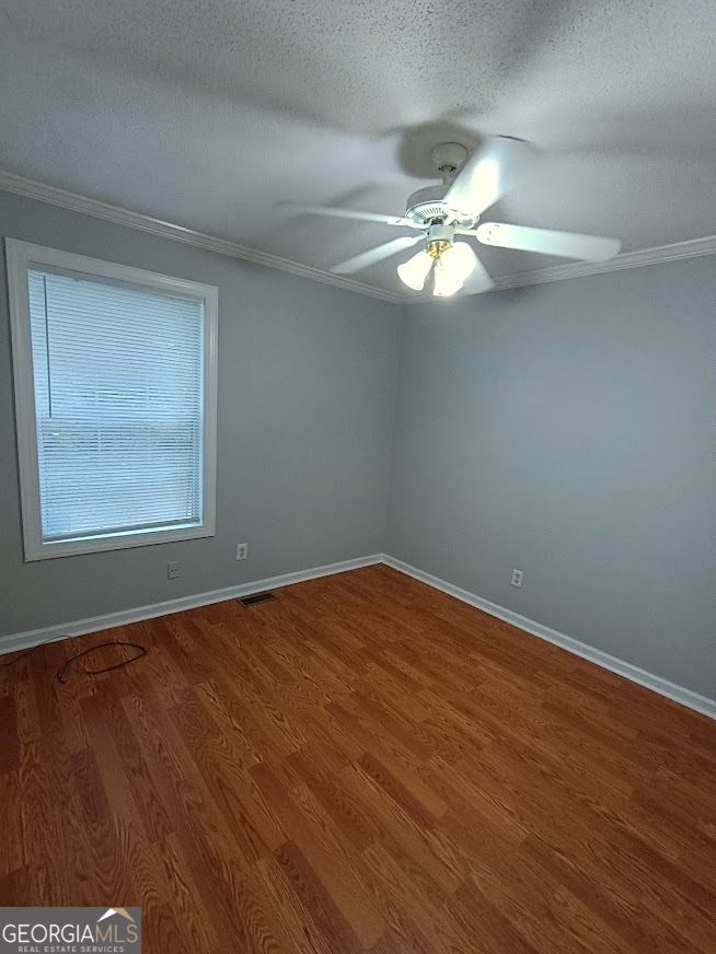 7355 Drake Avenue Lithonia, GA 30058 - Photo 17 of 20 an empty room with a window and a fan