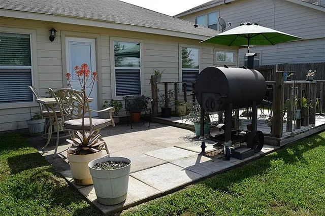 a view of a chairs and table in backyard