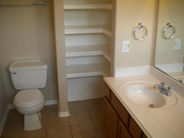 a bathroom with a sink toilet and vanity