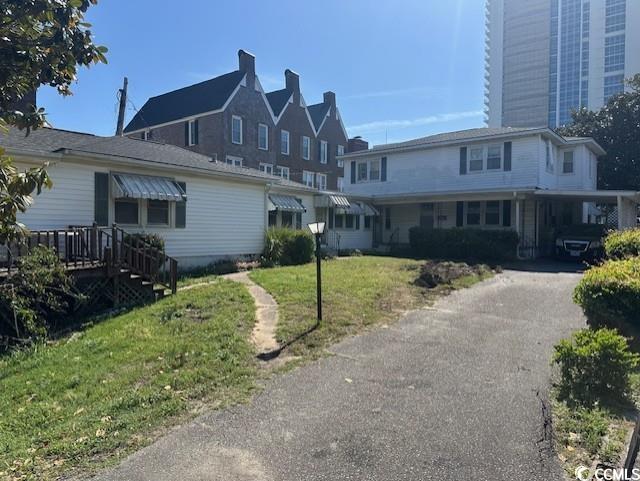 View of front of house with a front yard and driveway