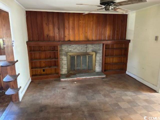 1504 Chester Street Myrtle Beach, SC 29577 - Photo 10 of 15 Unfurnished living room with a brick fireplace, baseboards, ornamental molding, and ceiling fan