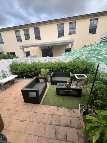 a view of a yard with chairs