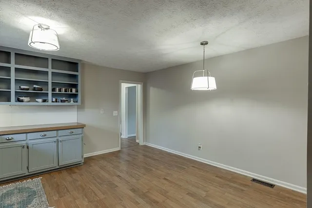 a view of a kitchen with a sink cabinets and wooden floor