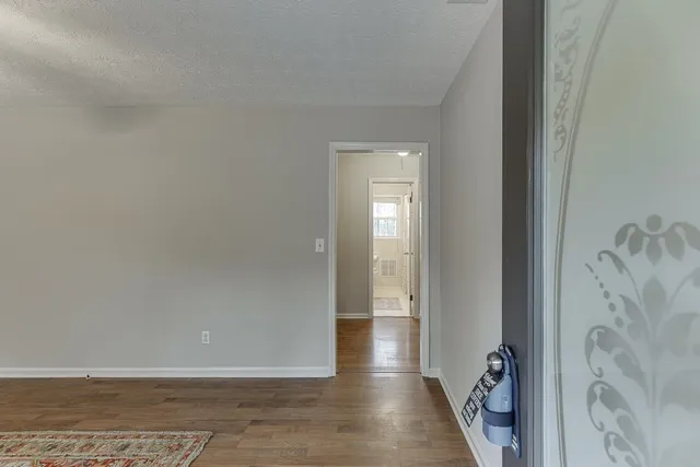 a view of a hallway with wooden floor