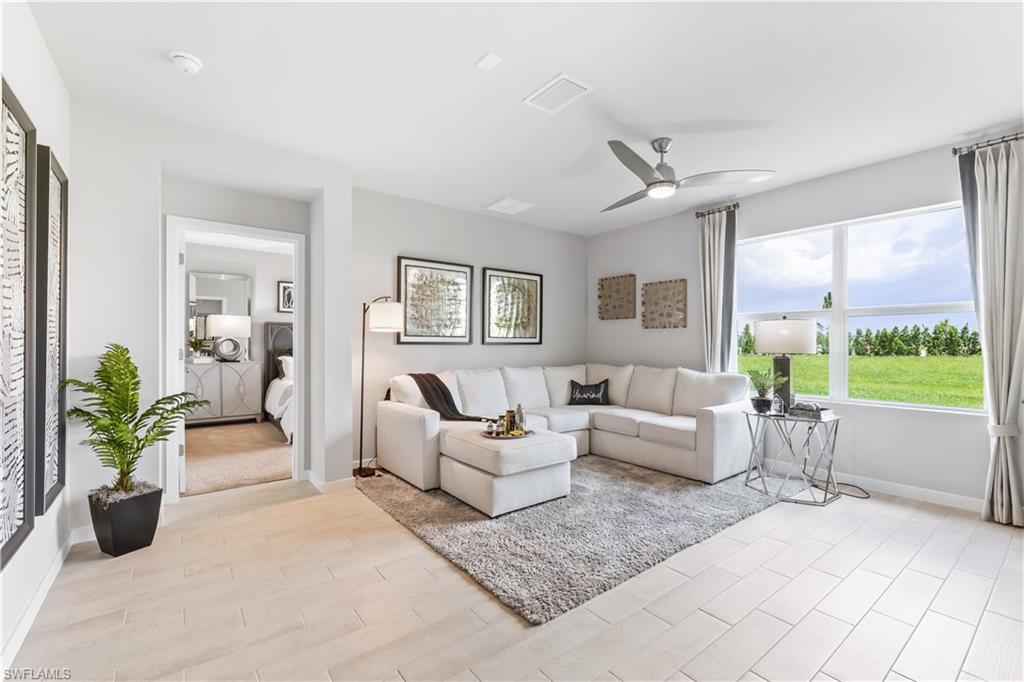 17767 Shade Tree Loop Punta Gorda, FL 33982 - Photo 2 of 35 a living room with furniture and a garden