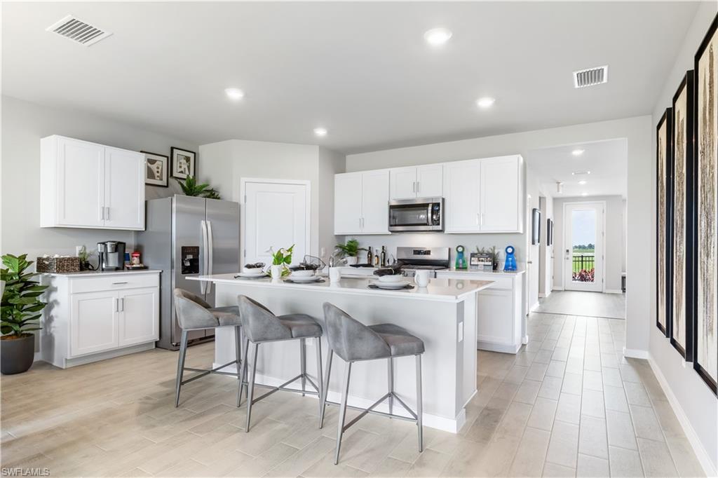 17767 Shade Tree Loop Punta Gorda, FL 33982 - Photo 4 of 35 a kitchen with appliances a sink a counter top space and cabinets