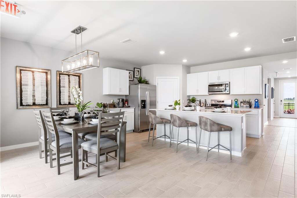 17767 Shade Tree Loop Punta Gorda, FL 33982 - Photo 5 of 35 a view of a dining room with furniture and window