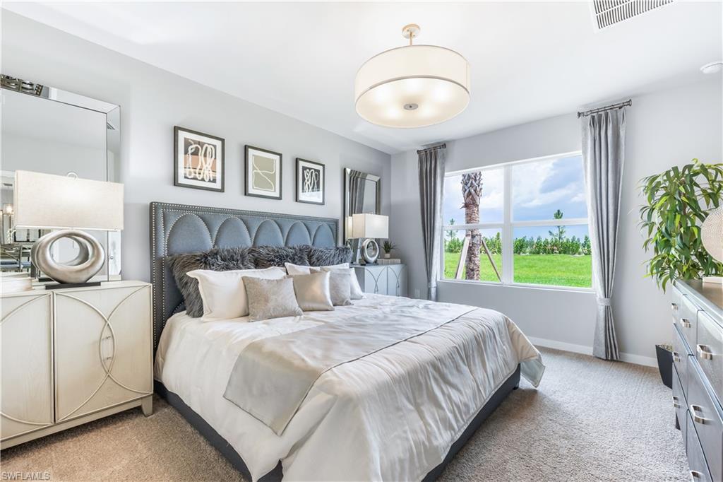 17767 Shade Tree Loop Punta Gorda, FL 33982 - Photo 7 of 35 a bed room with a bed and a large window