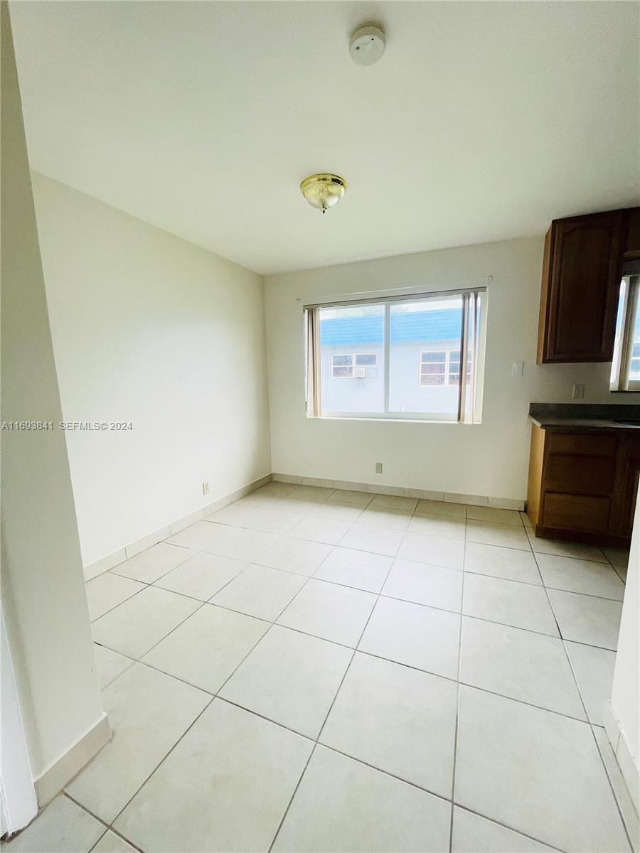 5261 Southwest 90th Way, Unit 3 Cooper City, FL 33328 - Photo 3 of 7 a view of an empty room with a window