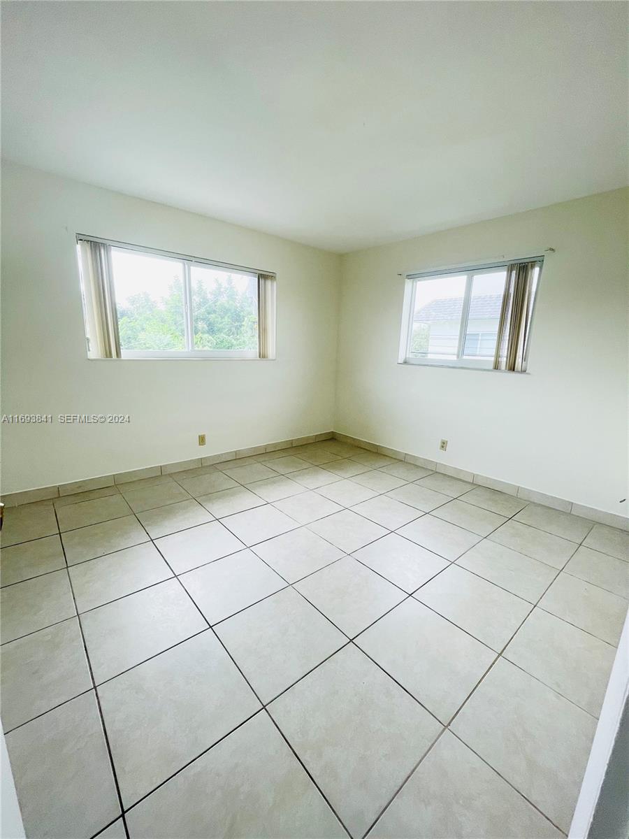 5261 Southwest 90th Way, Unit 3 Cooper City, FL 33328 - Photo 5 of 7 a view of an empty room with a window
