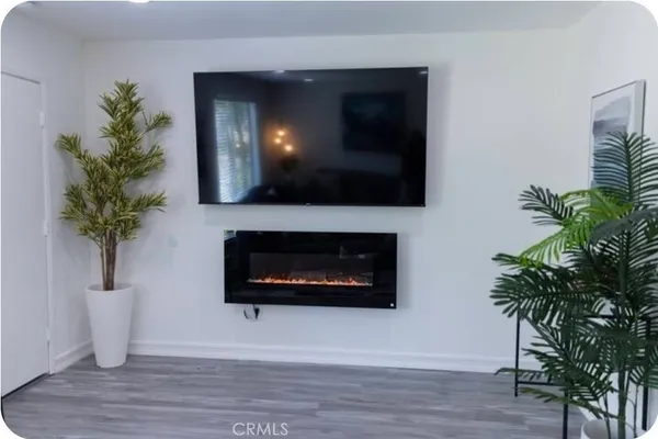 a living room with a potted plant and a fireplace
